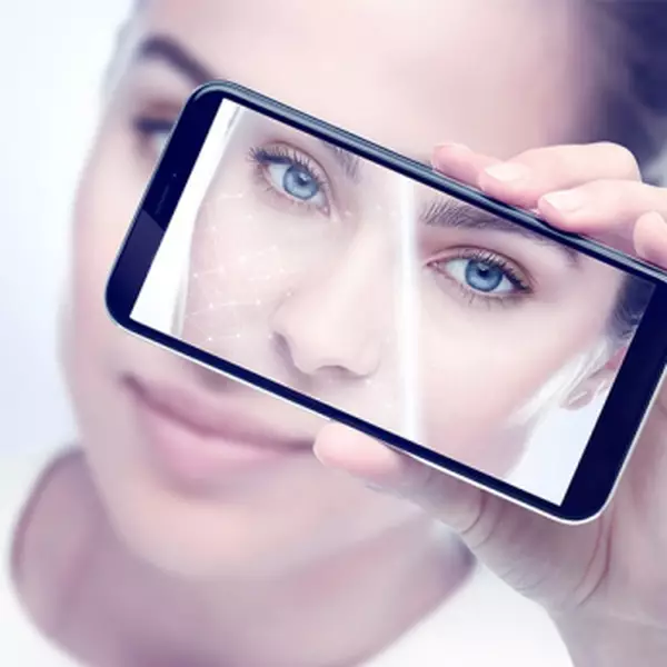 Woman taking a selfie with smartphone to use virtual beauty service tools and e-youth finder.