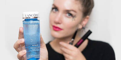 Woman showing how to remove Halloween makeup and waterproof mascara using eye makeup remover.