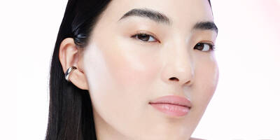 Young woman showing the visible signs of premature aging of the skin