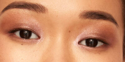 Close up of a glam rose gold eyeshadow look on brown eyes with monolids