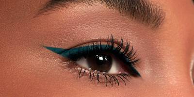 Emerald Green Eyeliner in a winged shape worn on brown eyes and dark skin
