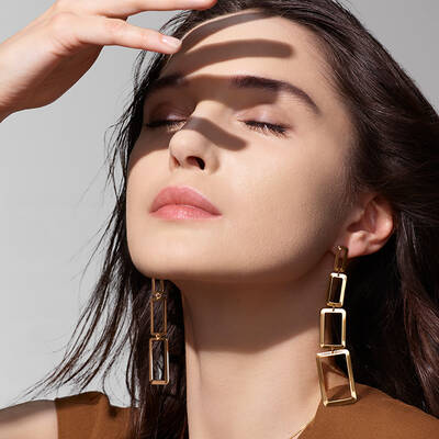 Woman facing the hot sun wearing summer makeup by Lancome