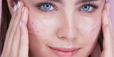 Woman practicing how to exfoliate face with the Lancome Rose Sugar Exfoliating Scrub