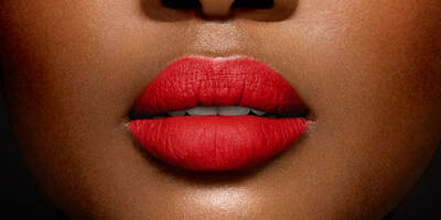 Cool Bright Red Lipstick in a Matte Finish worn on a dark skin tone