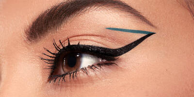 Graphic eyeliner look with green matte liquid eyeliner and black glossy liquid eyeliner