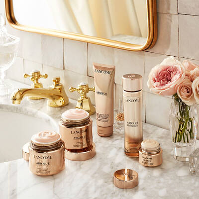 Lancome Absolue luxury skincare routine laid out on a bathroom sink counter