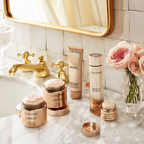 Lancome Absolue luxury skincare routine laid out on a bathroom sink counter