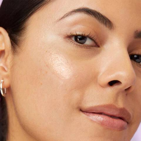 Woman with a dark spot corrector on skin to help with dark spots