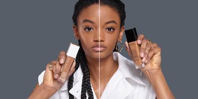Model holding bottles Teint Idole Matte Foundation and Teint Idole Care & Glow Foundation.