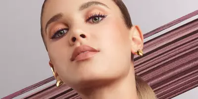Caucasian woman wearing the Lancome eye makeup look in burgundy tones