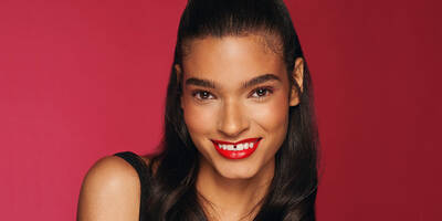 Soft Powder Winged Eyeliner in a colorful shade worn on Medium Brown Skin with a red lip