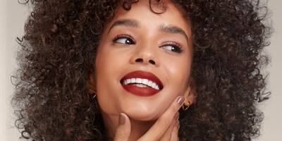 Maroon Burgundy Lipstick shade in a matte finish worn on a dark skin tone.