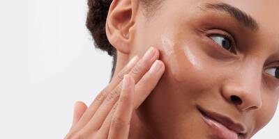 Woman applying face serum with PHA Poly hydroxy acid to skin