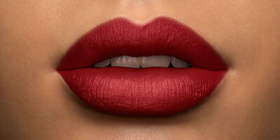 Scarlet Red Lipstick a Matte Finish worn on a medium skin tone