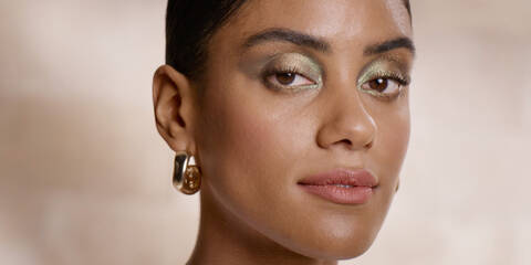 Model wearing a bronze makeup look created using Lancome x The Louvre multi-use eyeshadow palette