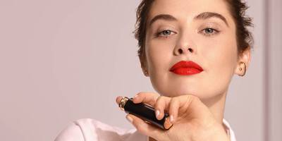 Woman wearing red lipstick and subtle natural eyeliner for a red valentine’s day makeup look.