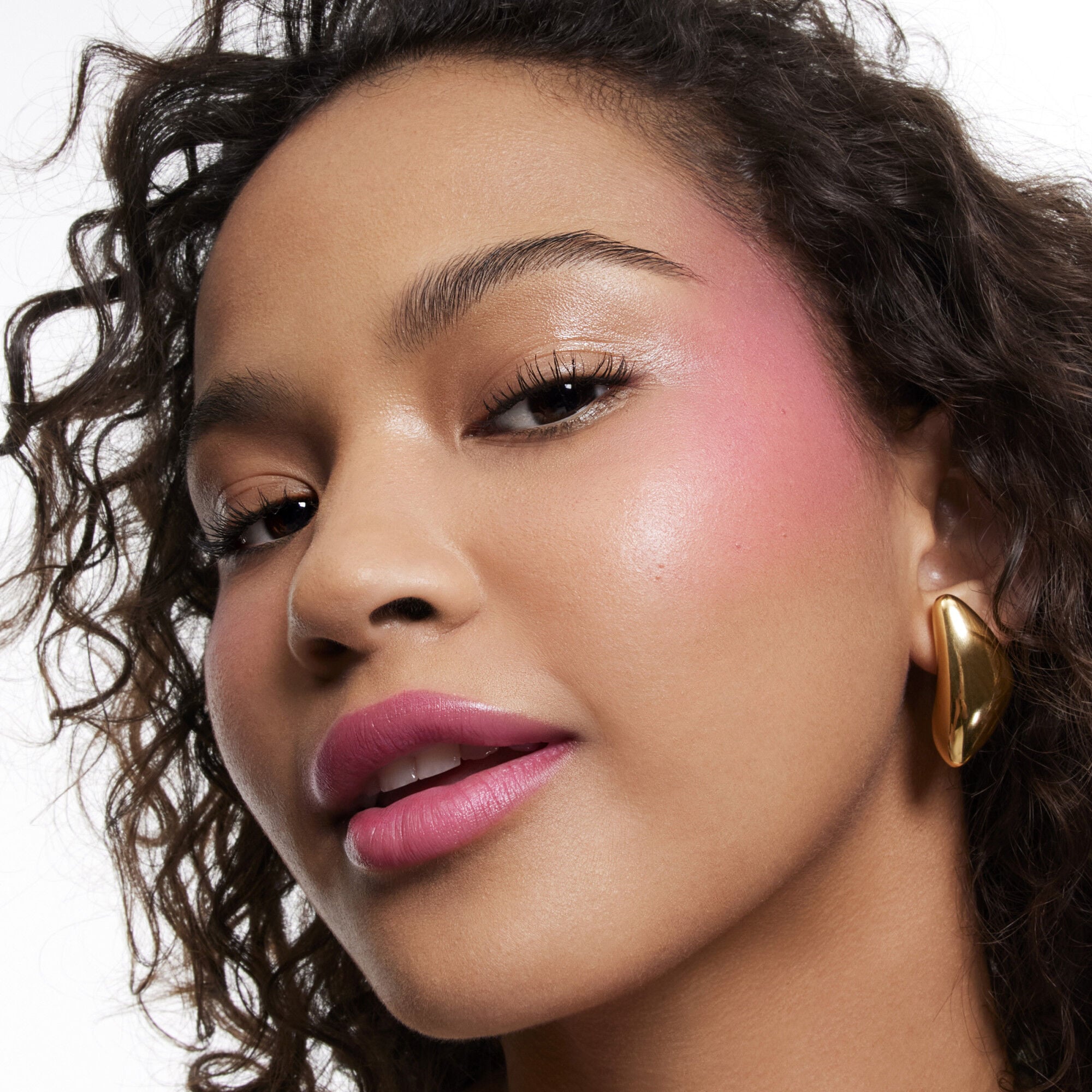 Travel Blush Stick Cheek Color Balm Holiday 2025 applied on a medium skin tone for comparison 