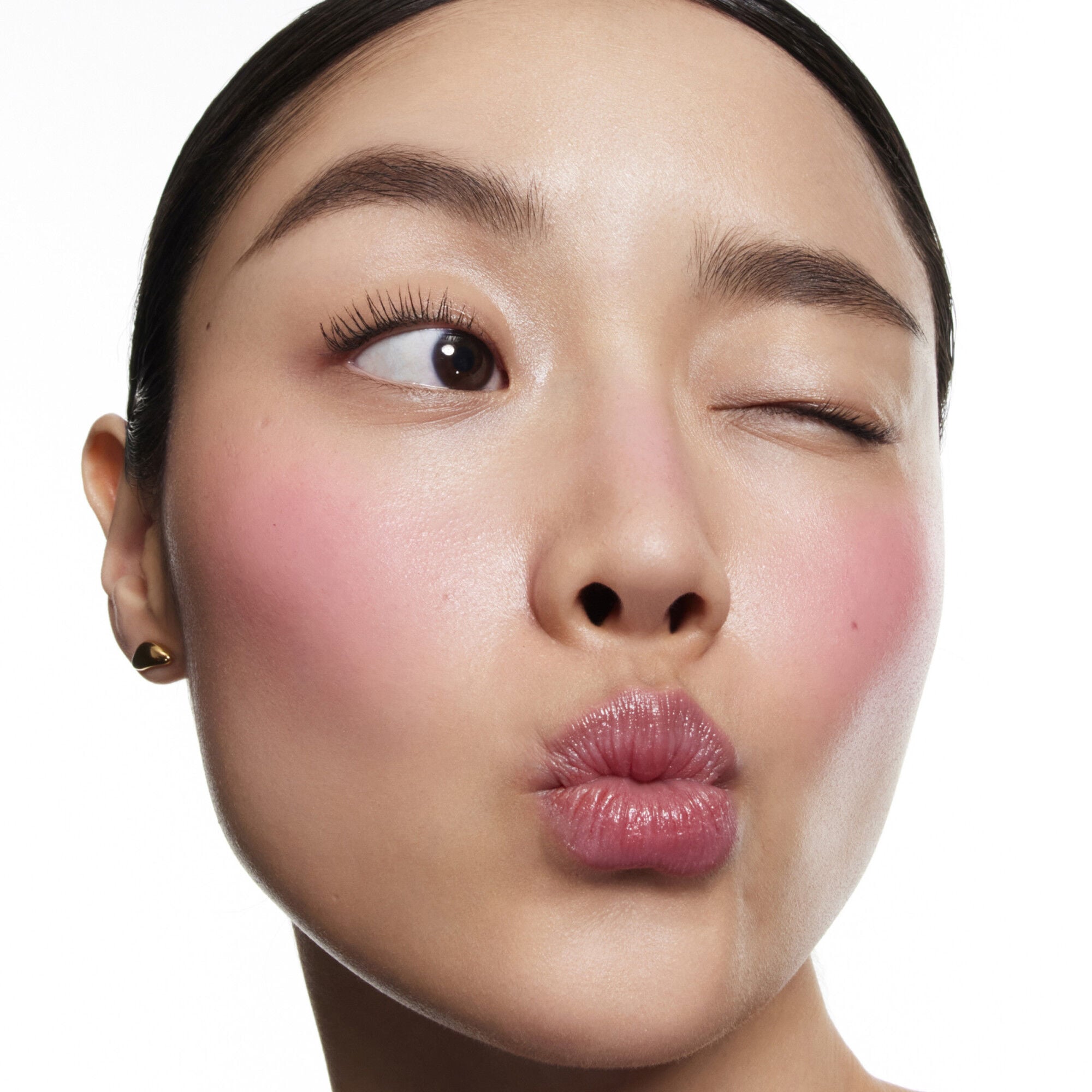 Travel Blush Stick Cheek Color Balm Holiday 2025 applied on a light skin tone for comparison 
