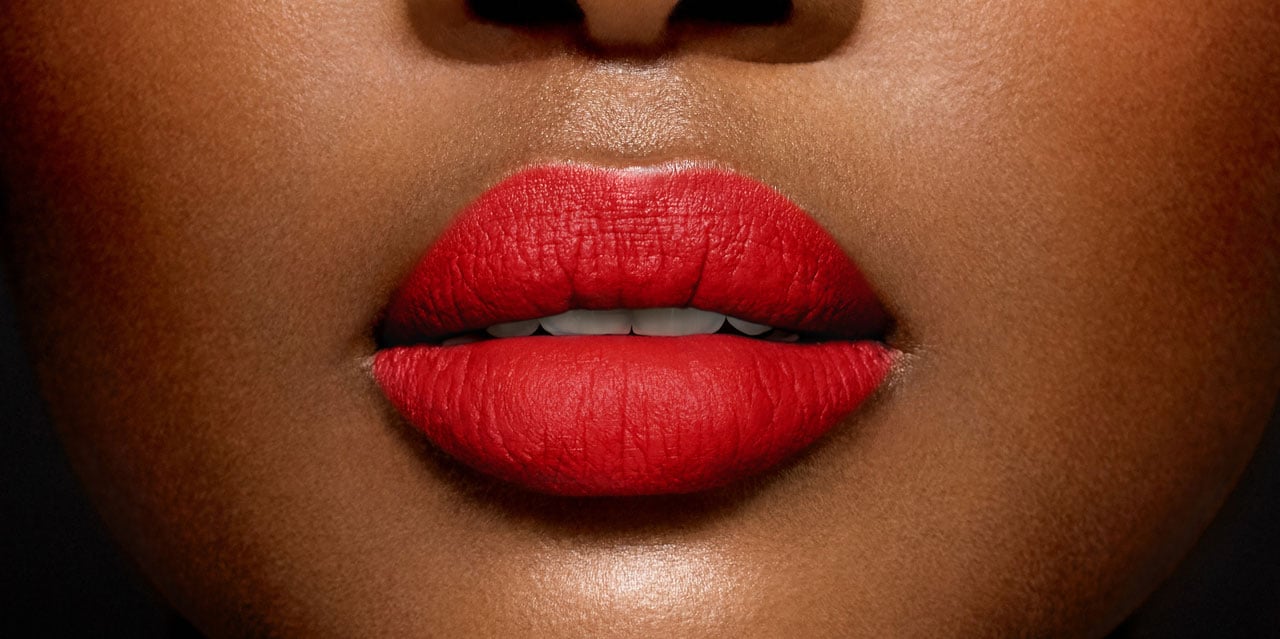 Woman wearing bright red lipstick for dark skin