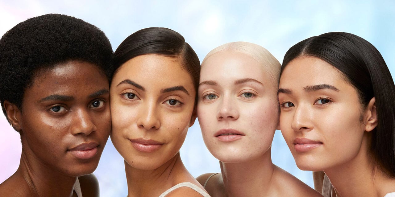 Women with dark skin, medium skin, and fair skin with dark spots on face