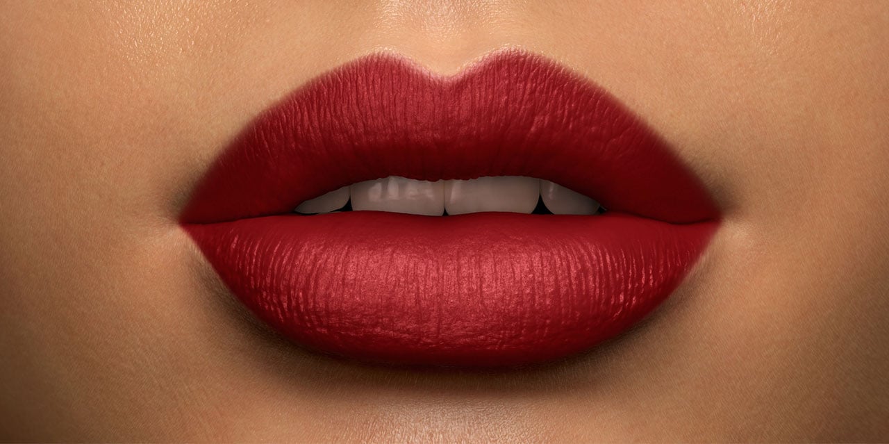 Woman wearing warm red lipstick for olive skin